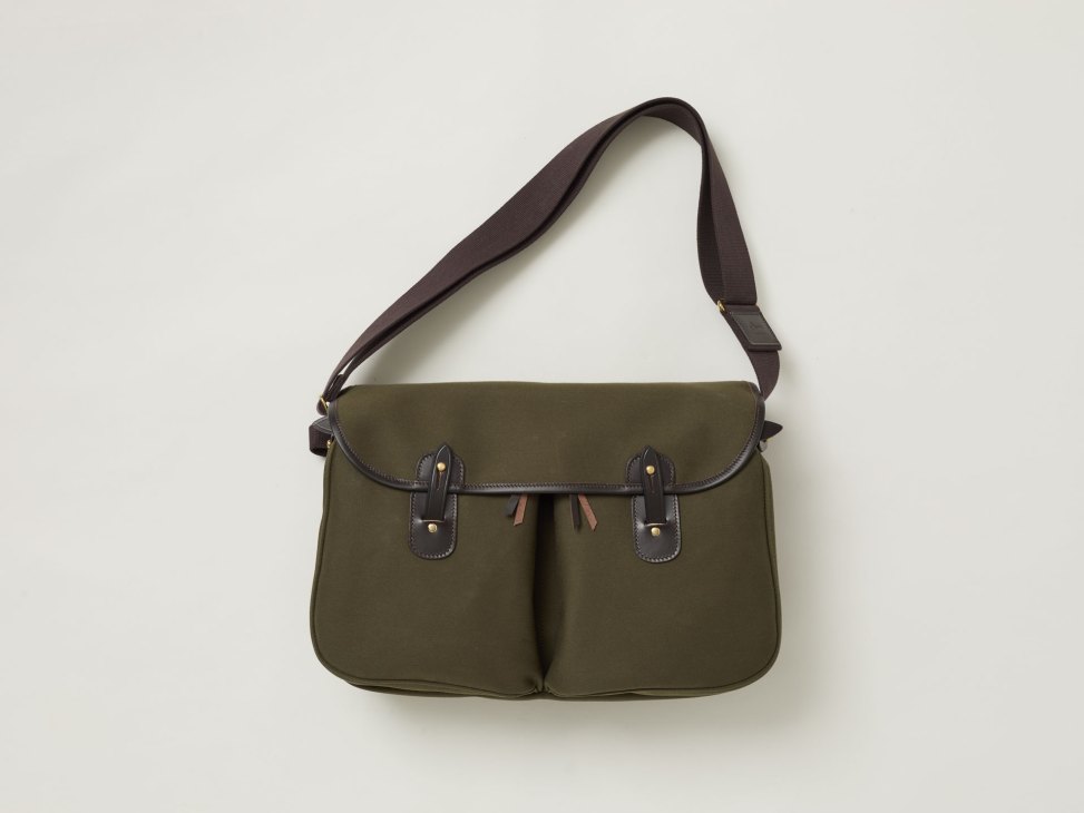 Olive green canvas messenger bag with brown leather trim and adjustable shoulder strap