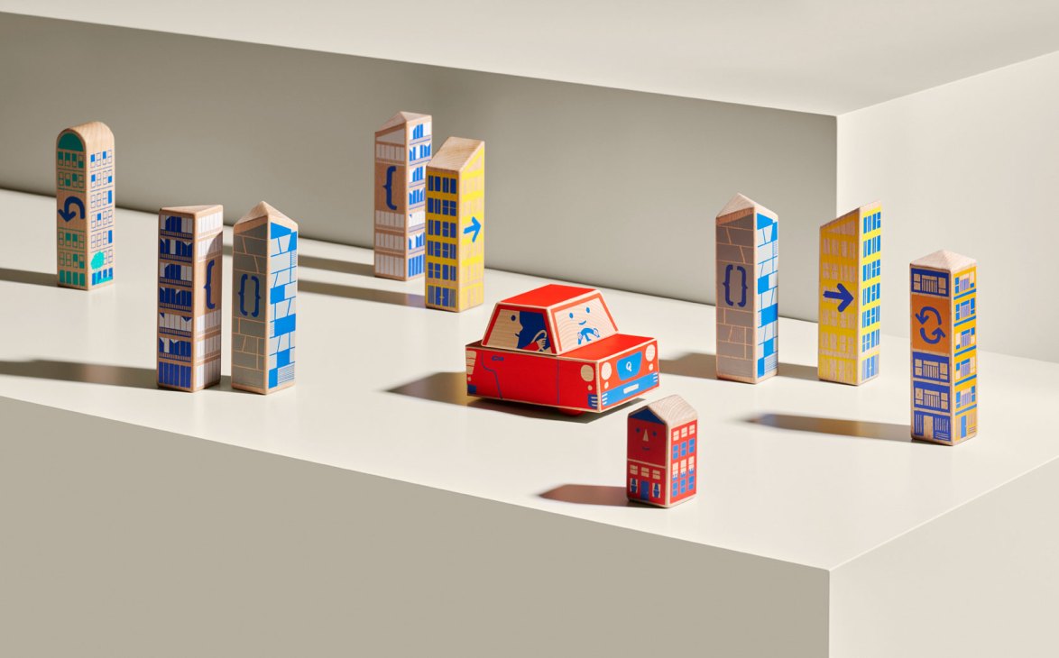 Qubs Cody Block toy car system with wooden building blocks and red toy car on white stepped display