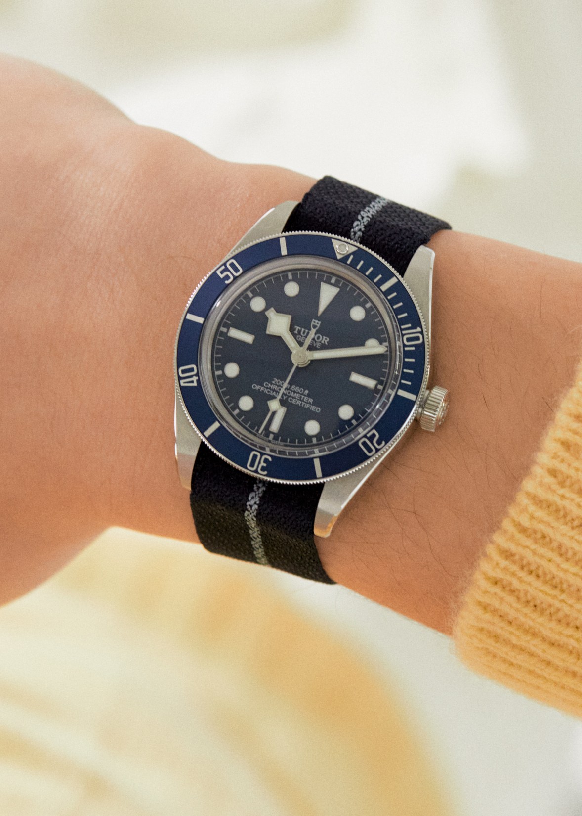 Tudor Black Bay Fifty-Eight Navy Blue watch with blue dial and bezel on fabric strap worn on wrist