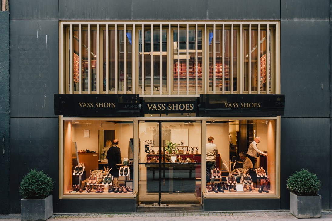Upper floor of Vass shoes workshop with rows of red shoe boxes for customers