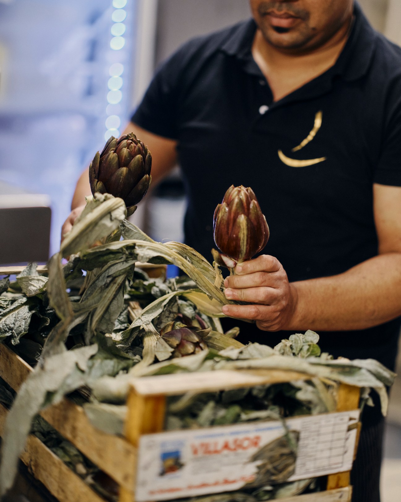 Staff member carting produce through Venice streets