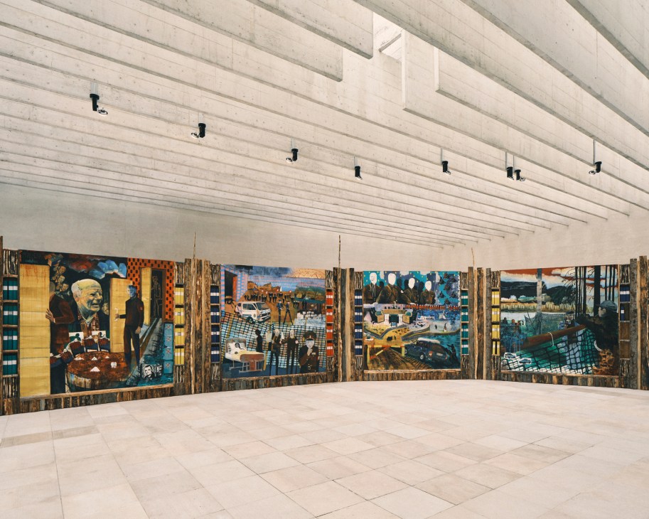 Large colorful painted panels displayed in a white gallery space with linear ceiling details.