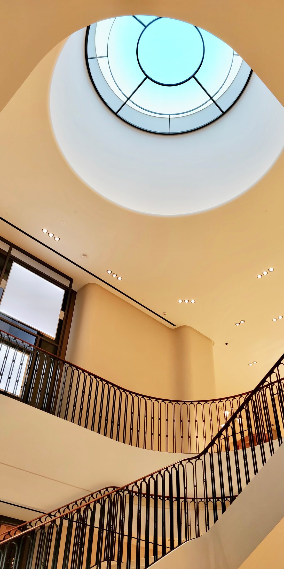 Light Cognitive LED lighting panel with blue-tinted circular light fixture mounted on cream ceiling.