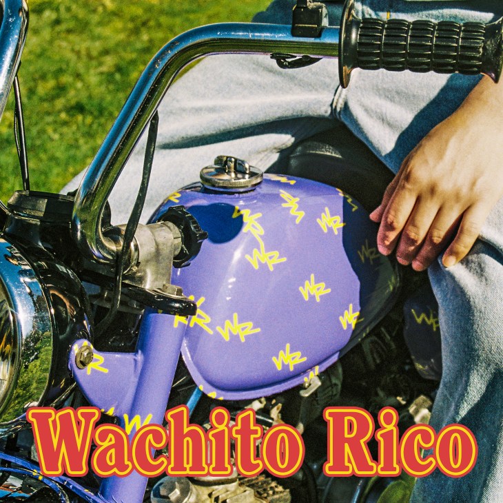 Boy Pablo's Wachito Rico album cover featuring motorcycle tank with blue and purple gradient and yellow text pattern