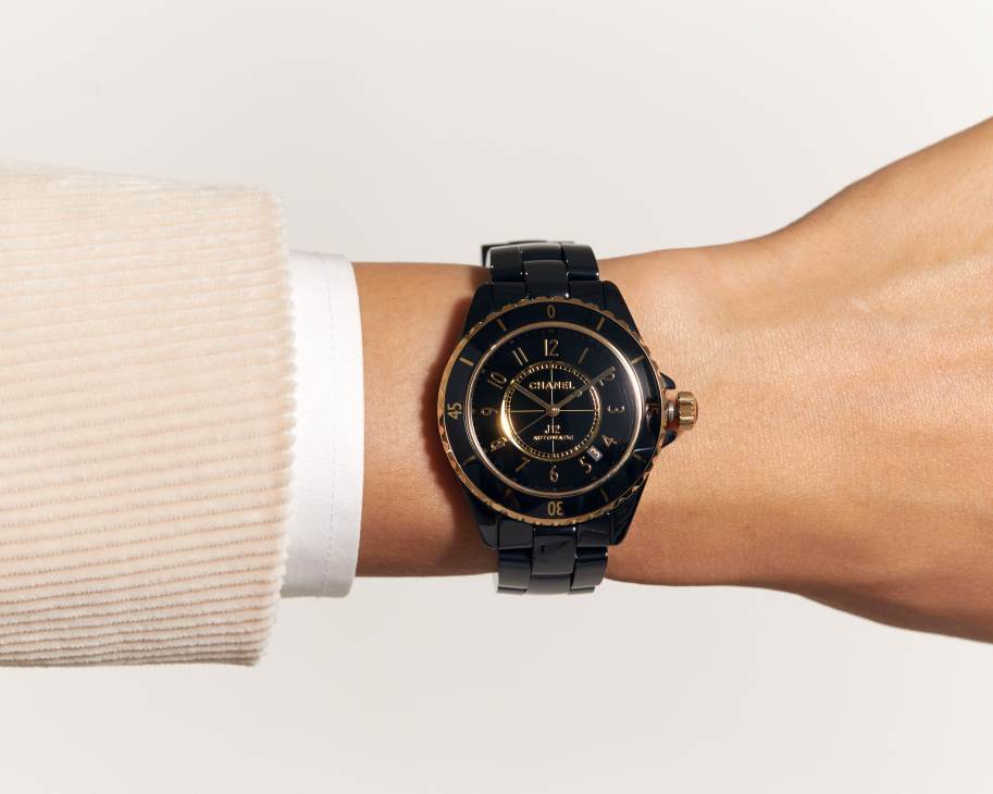Black ceramic Chanel J12 Calibre 12.1 watch with black dial and bracelet on white background