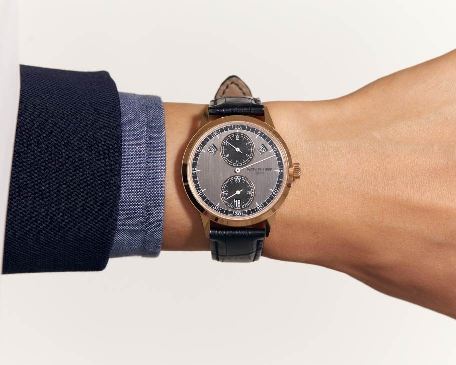 Patek Philippe Annual Calendar Regulator watch with dual subdials on gray face and black leather strap