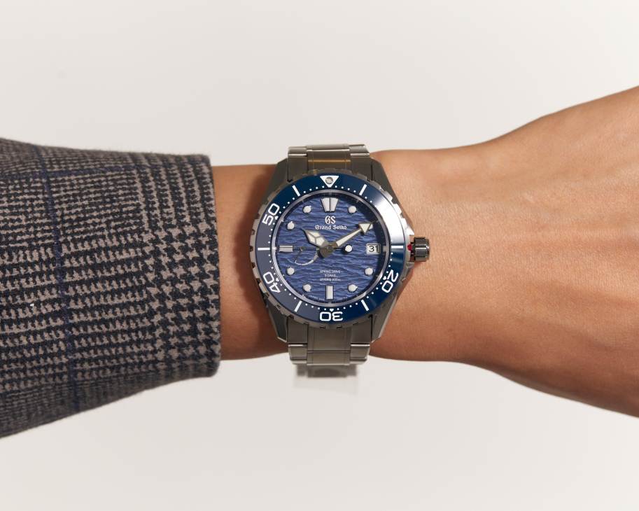 Grand Seiko Ushio Blue Spring Drive Diver's Watch with blue dial and steel bracelet on wrist