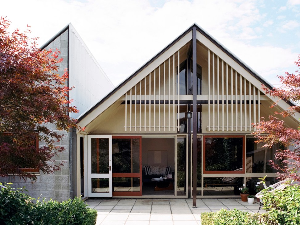 Modern concrete townhouses with pitched roofs and large windows designed by Warren & Mahoney