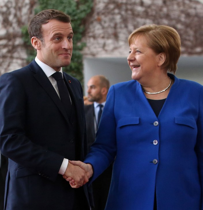 Angela Merkel and Emmanuel Macron standing together, representing their partnership on European issues