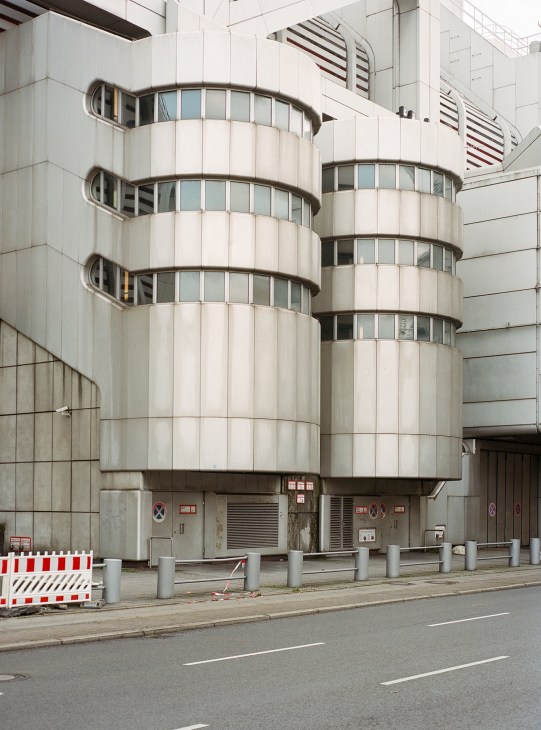 The International Congress Centre's cylindrical concrete and glass facade with curved windows and brutalist architecture in Berlin.