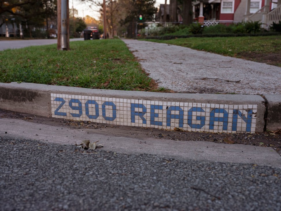 Close-up of blue tile street name mosaic in Houston curb