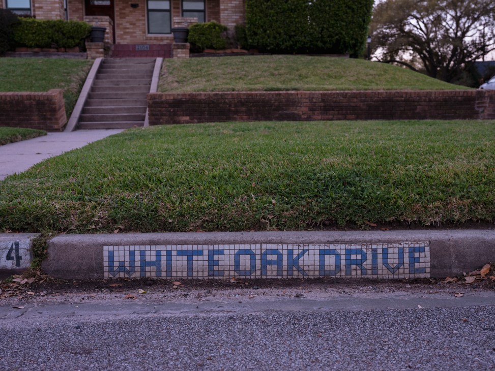 Historic Houston blue tile street marker embedded at street corner