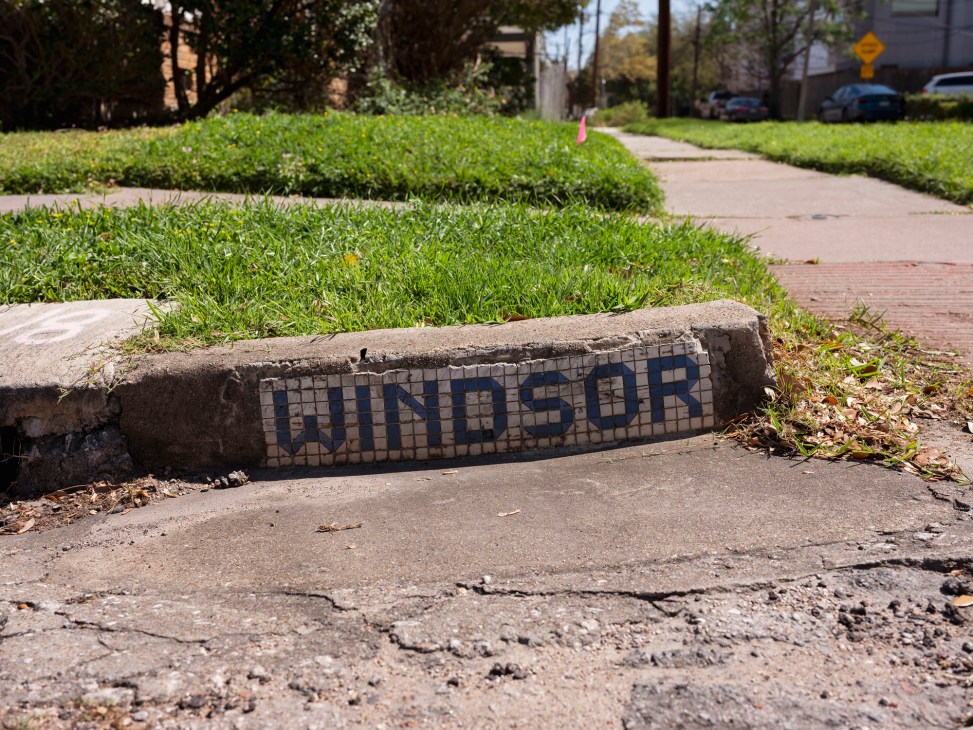 Vintage blue and white tiled street sign reading 'WINDSOR' embedded in Houston sidewalk