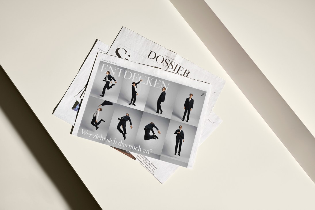 Die Zeit newspaper pages showing editorial design with photography including people in black clothing in grid layout