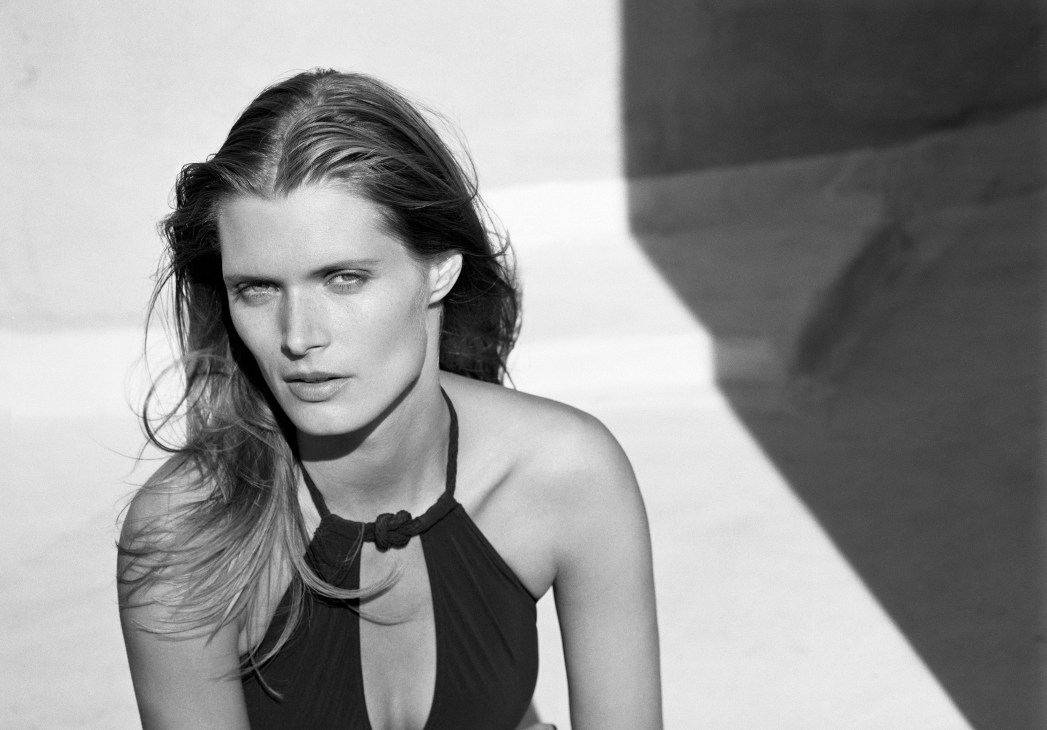Black and white portrait of a woman in elegant styling for a luxury fashion campaign