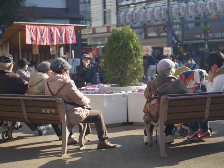 Elderly people sitting on benches.