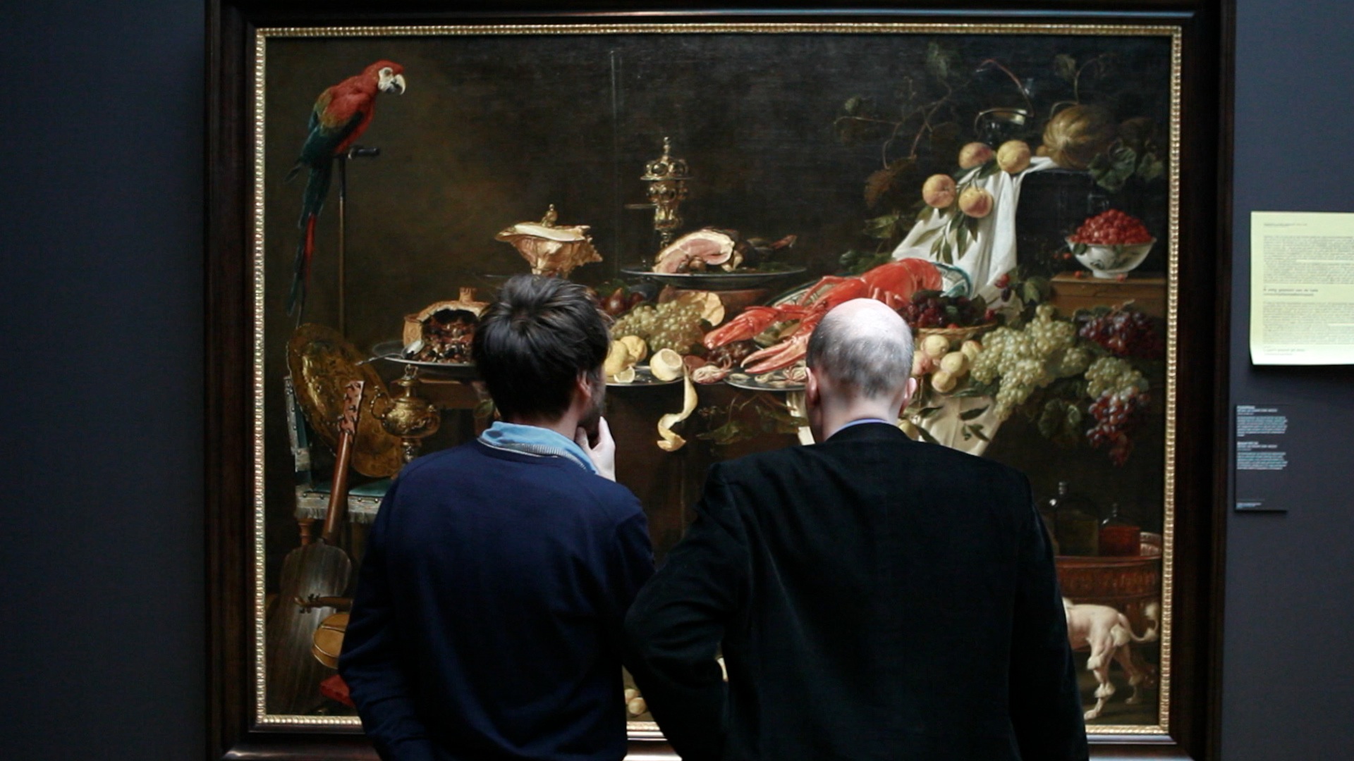 People observing a painting.