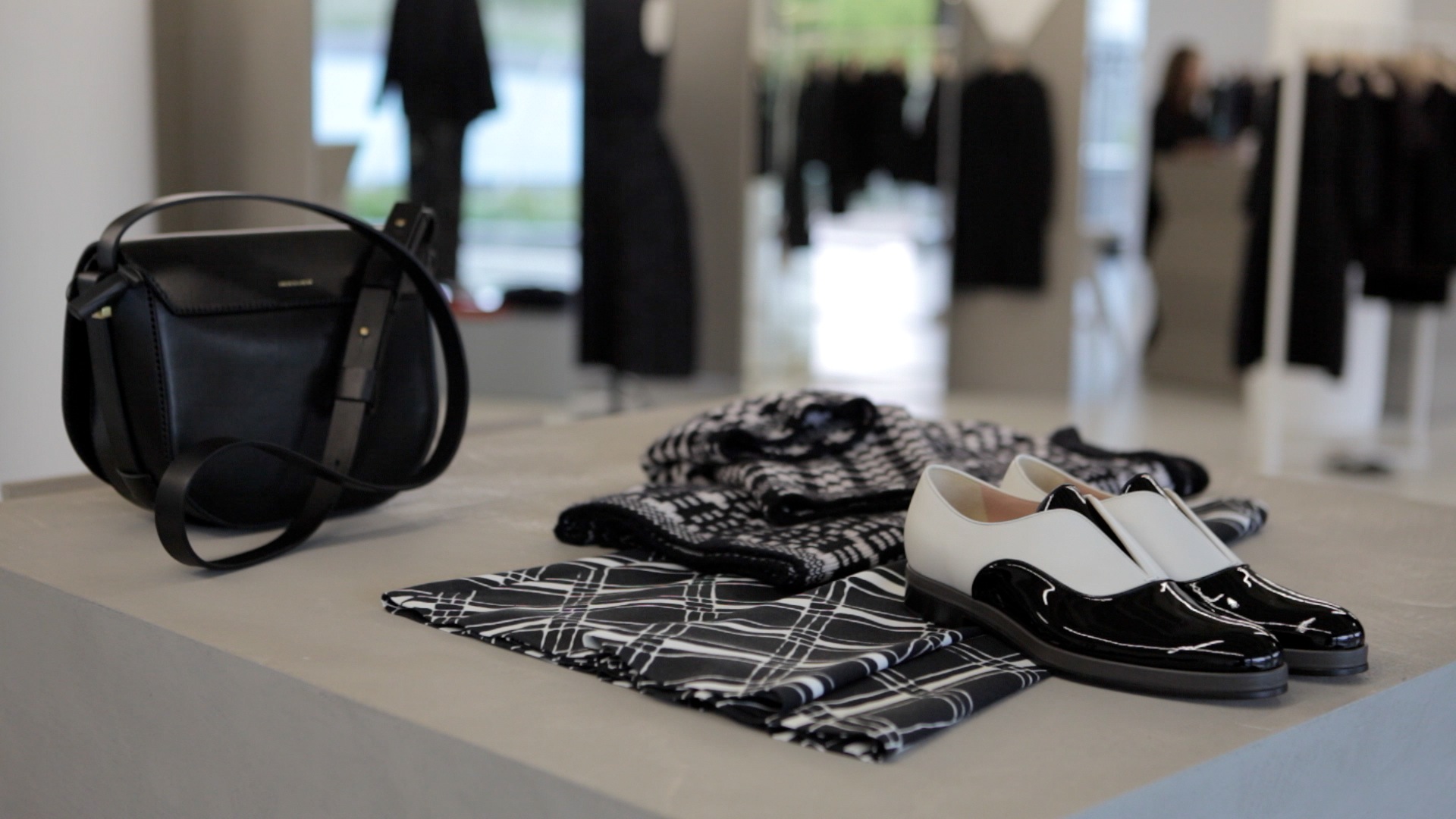 Shoes and fashion garments displayed in a shop.