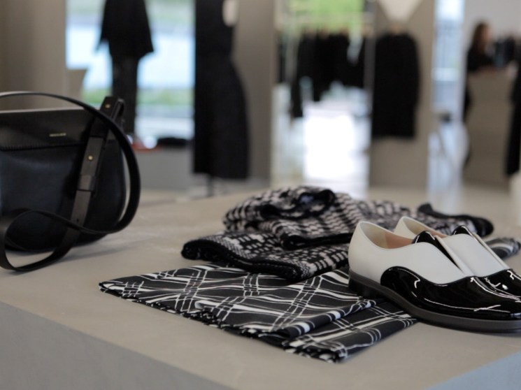 Shoes and fashion garments displayed in a shop.