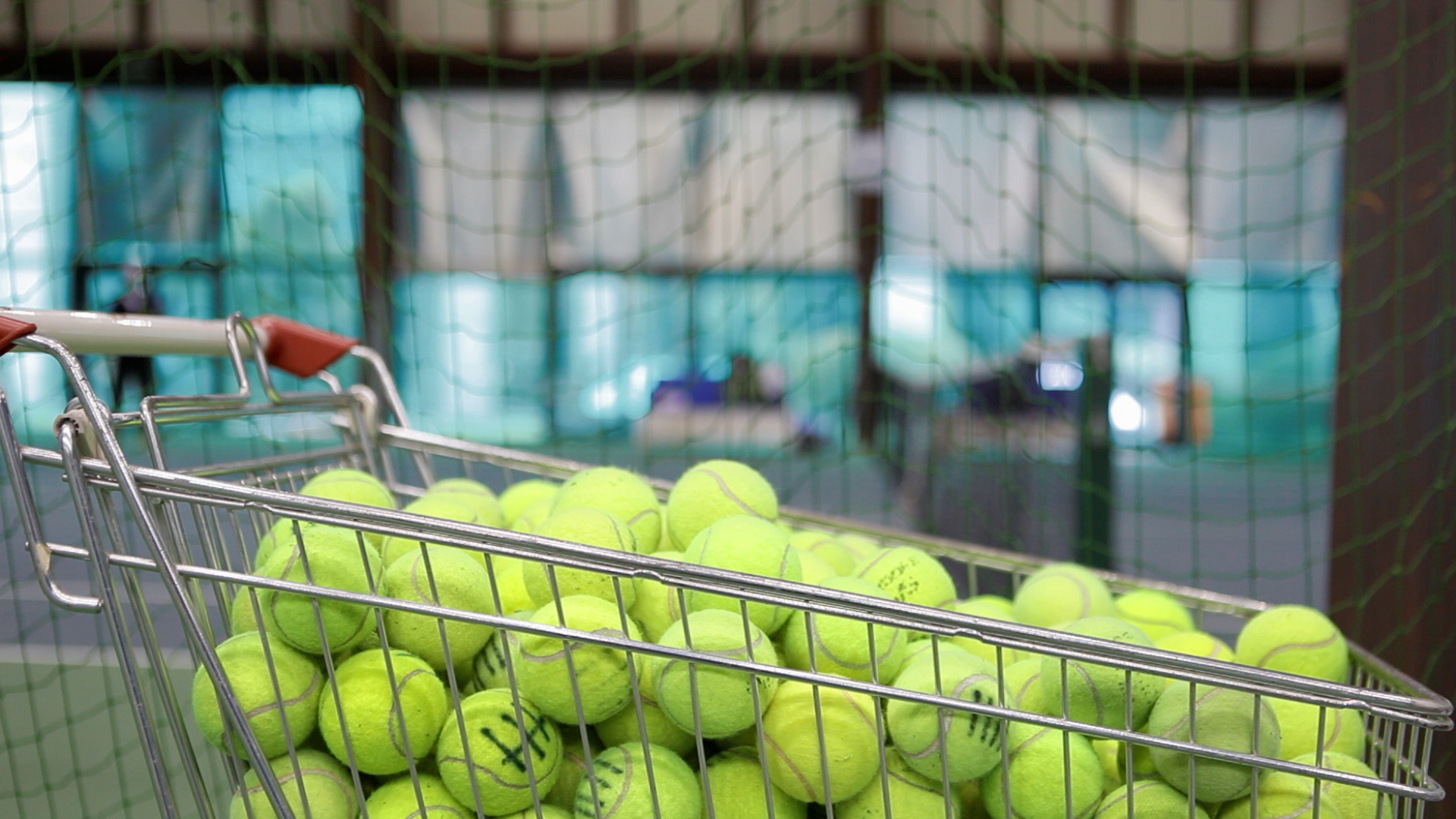 A cart filled with tennis balls.