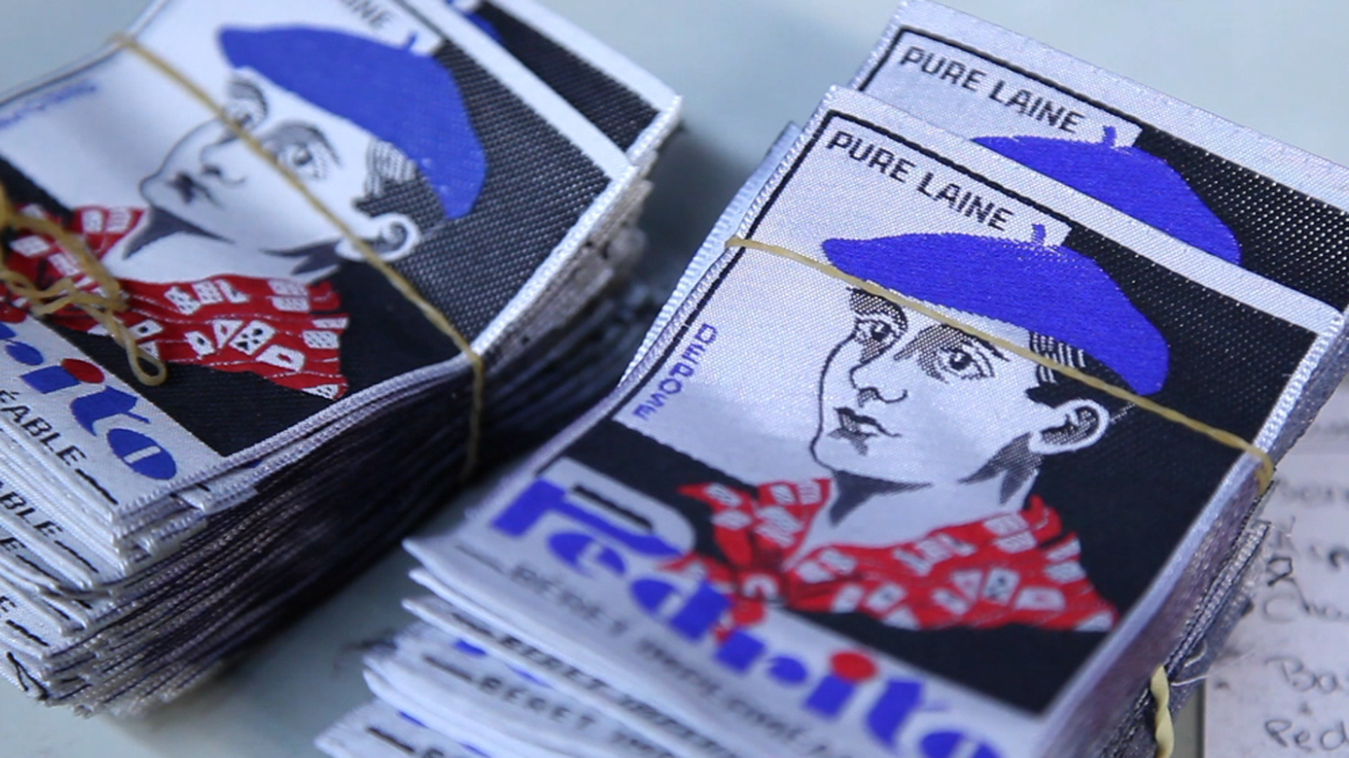 A tag depicting a man wearing a beret.