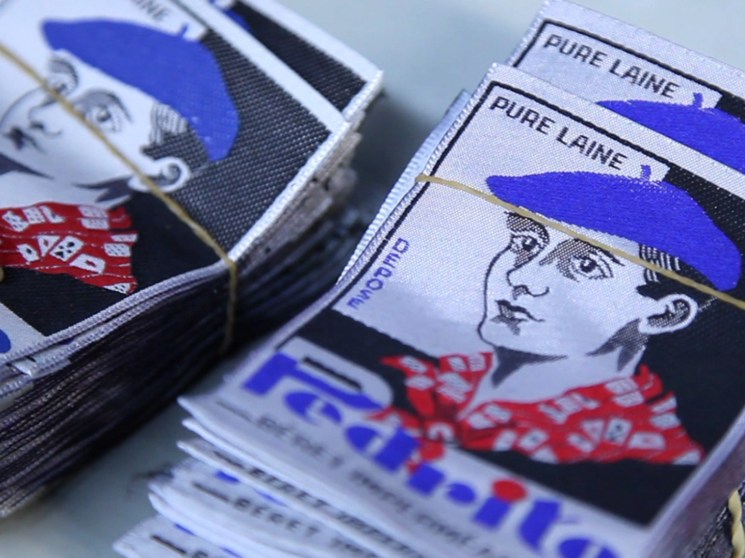 A tag depicting a man wearing a beret.