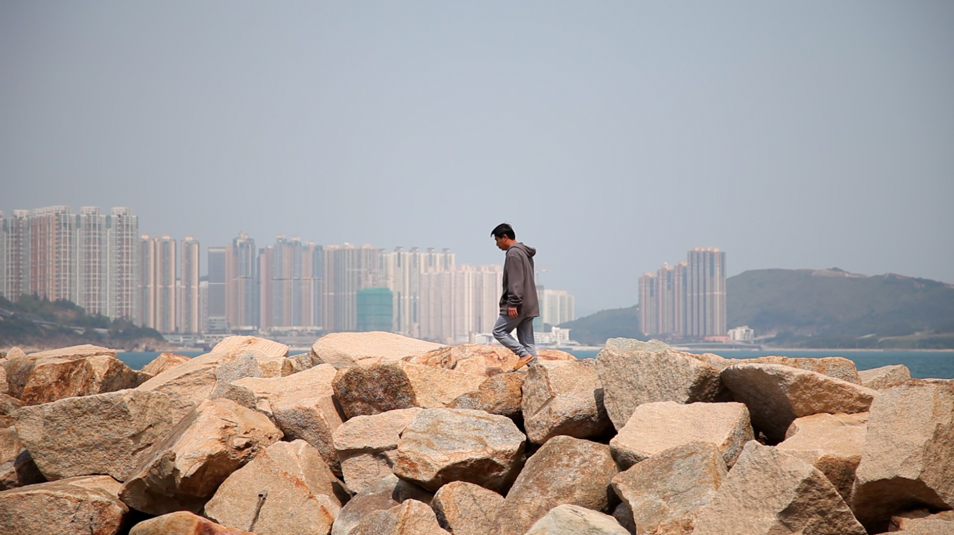 man at rock barrier