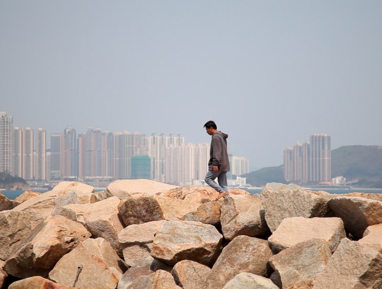 man at rock barrier