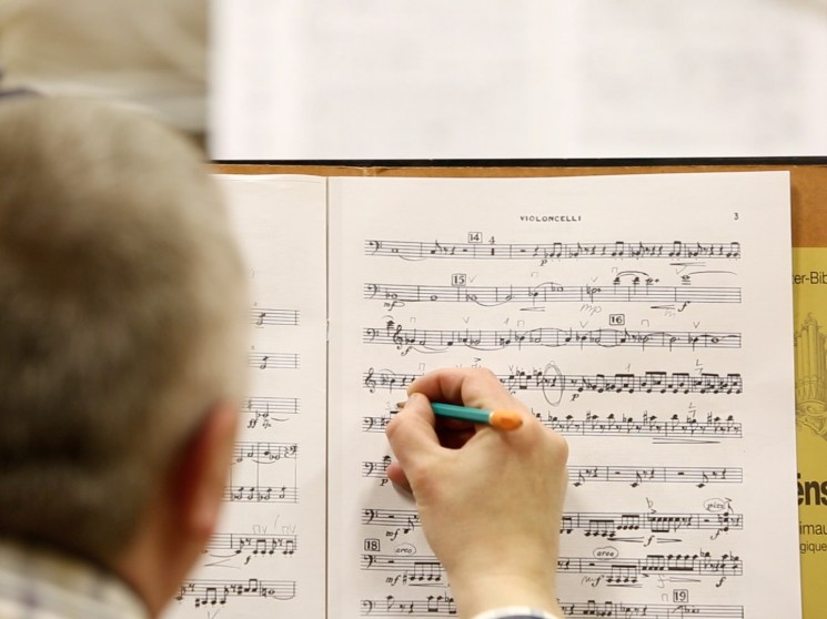 A musician amending the score.