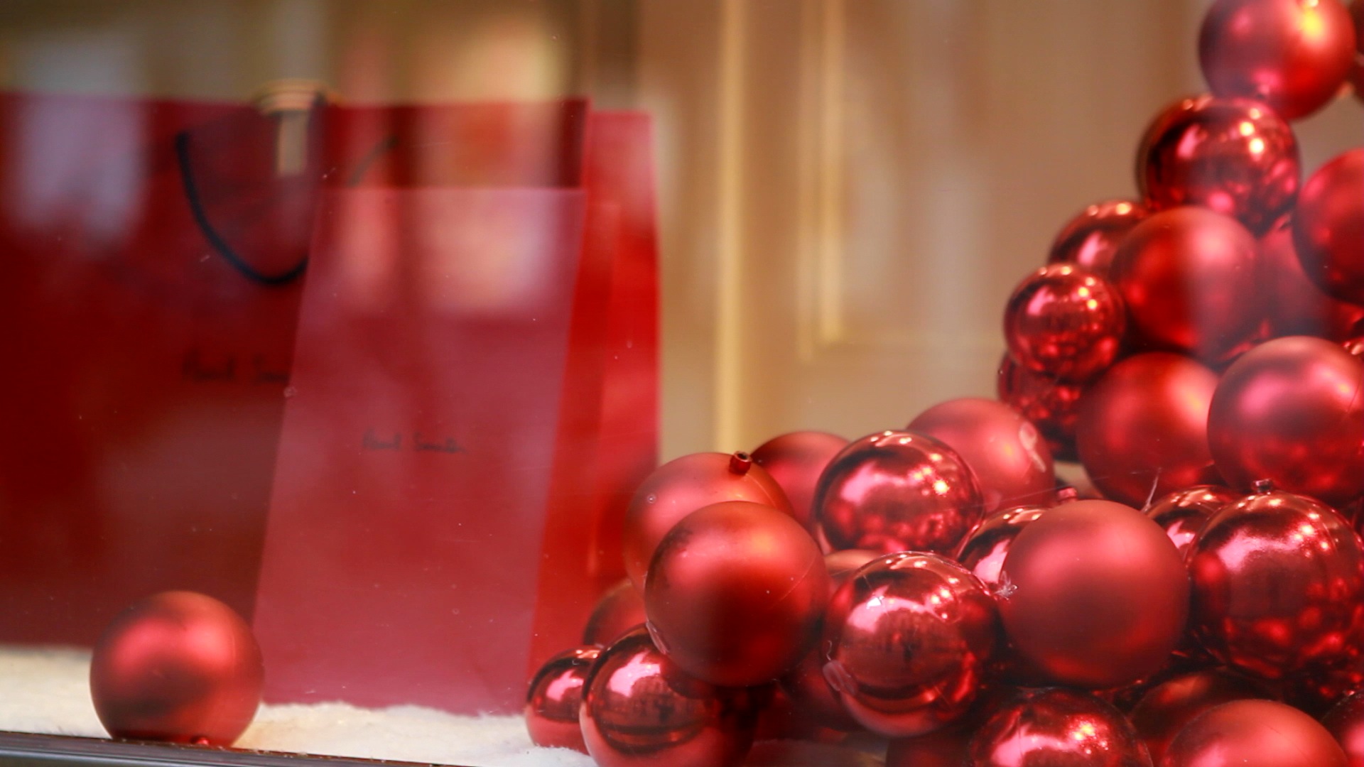 Christmas baubles in a window display.