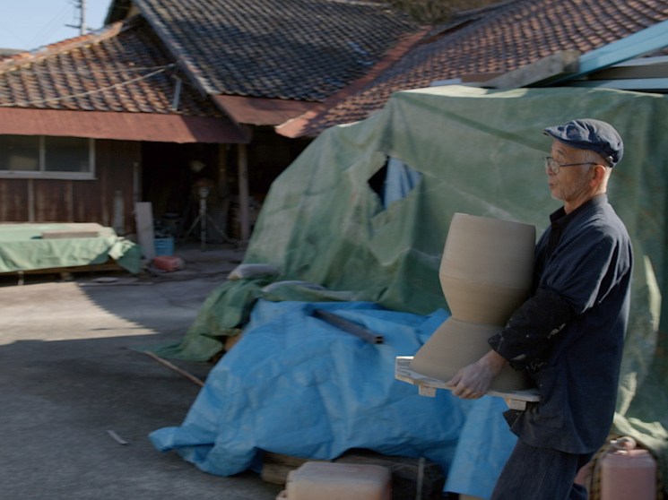 Craftsman carrying a sculpture