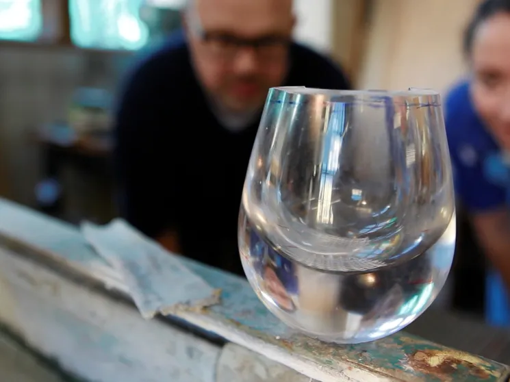 Makers observing a glas.