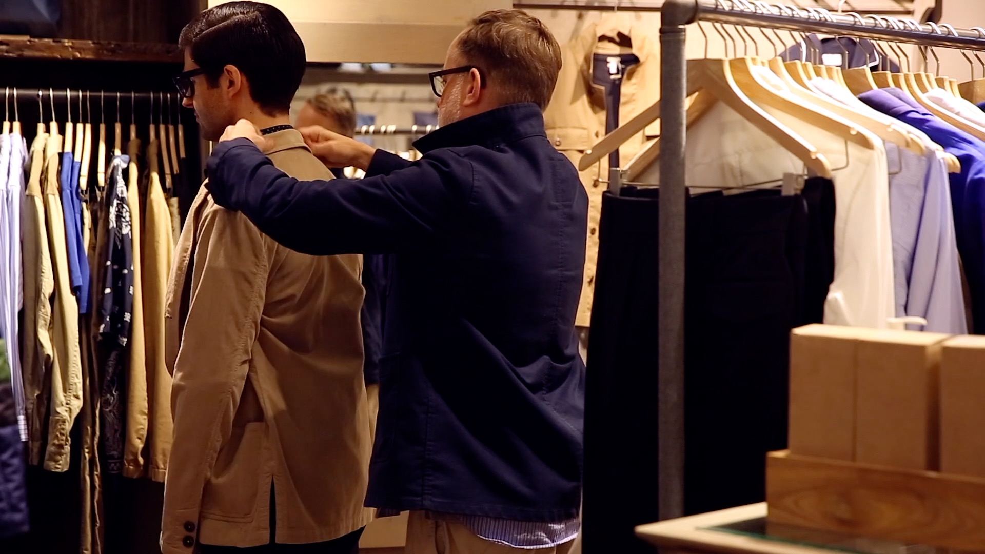 Trying a jacket on.