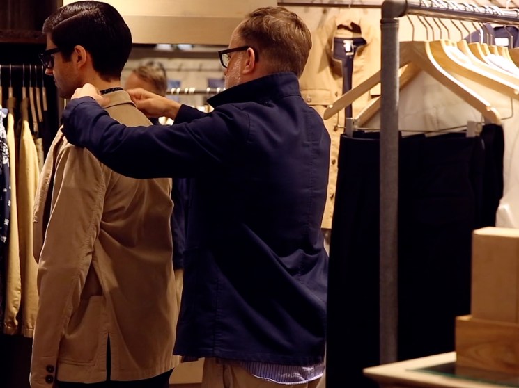 Trying a jacket on.