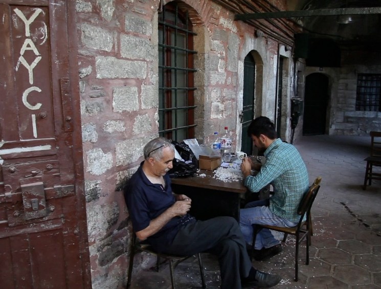 men sat in a courtyard
