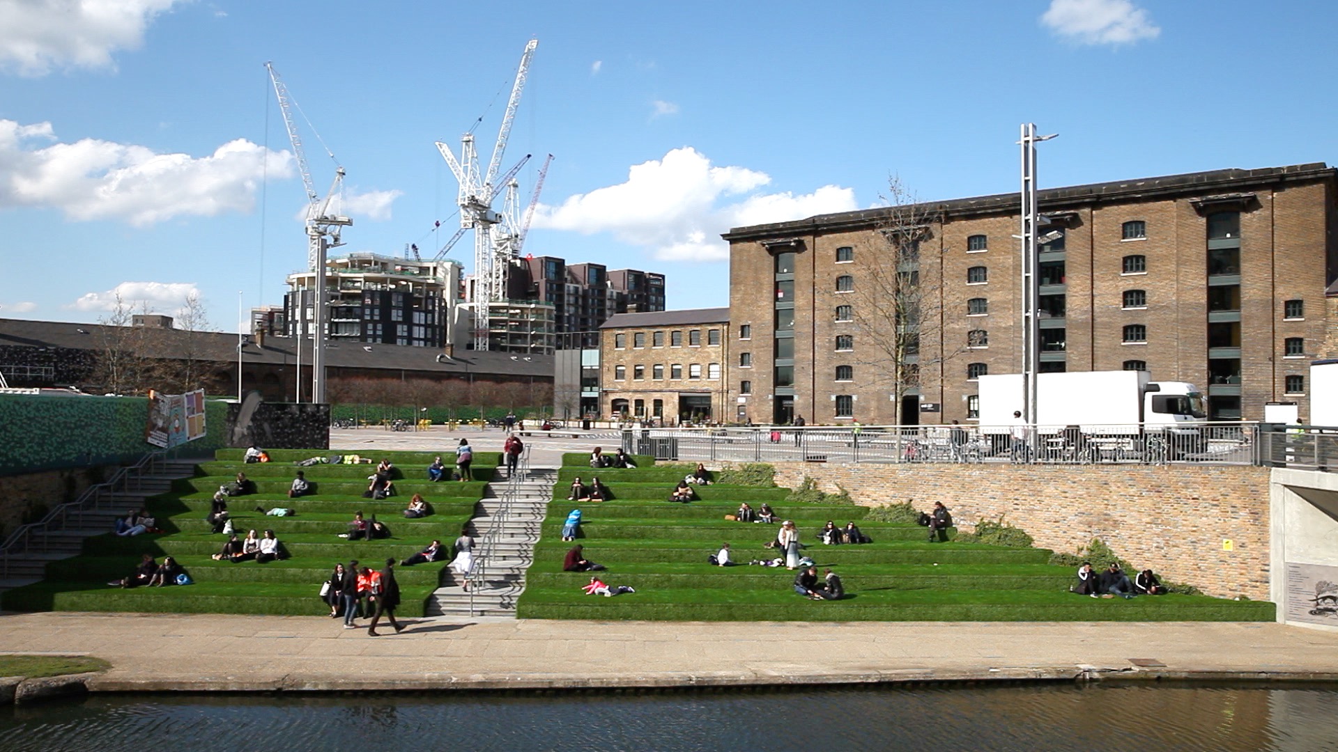 People sitting by the canal in London's Kings Cross.