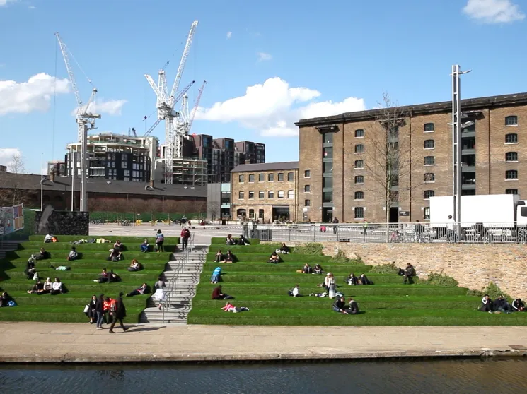 People sitting by the canal in London's Kings Cross.