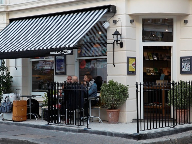 People sitting at the terrace of Kioskafe in London.