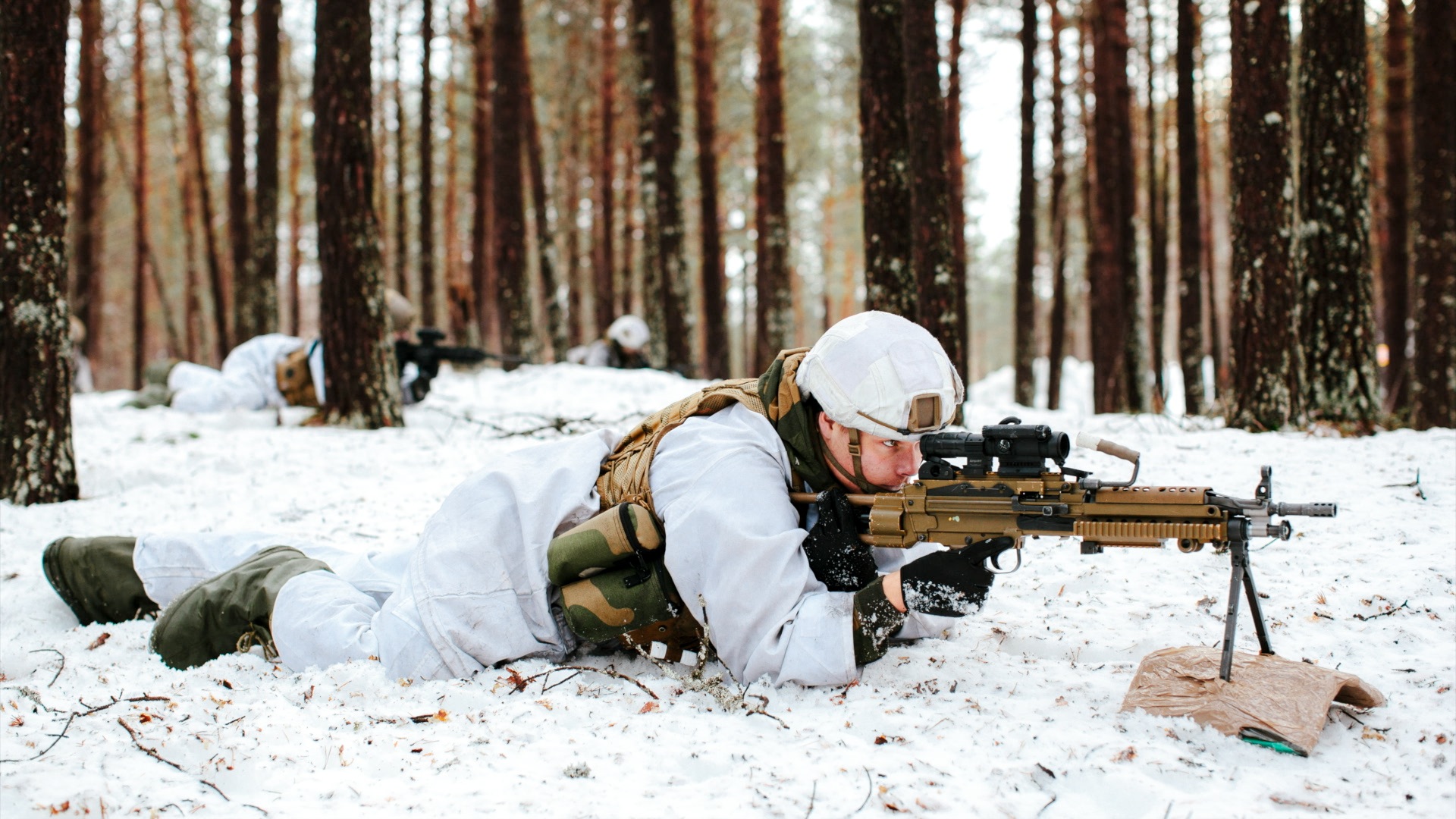 A soldier training in snowy woods.