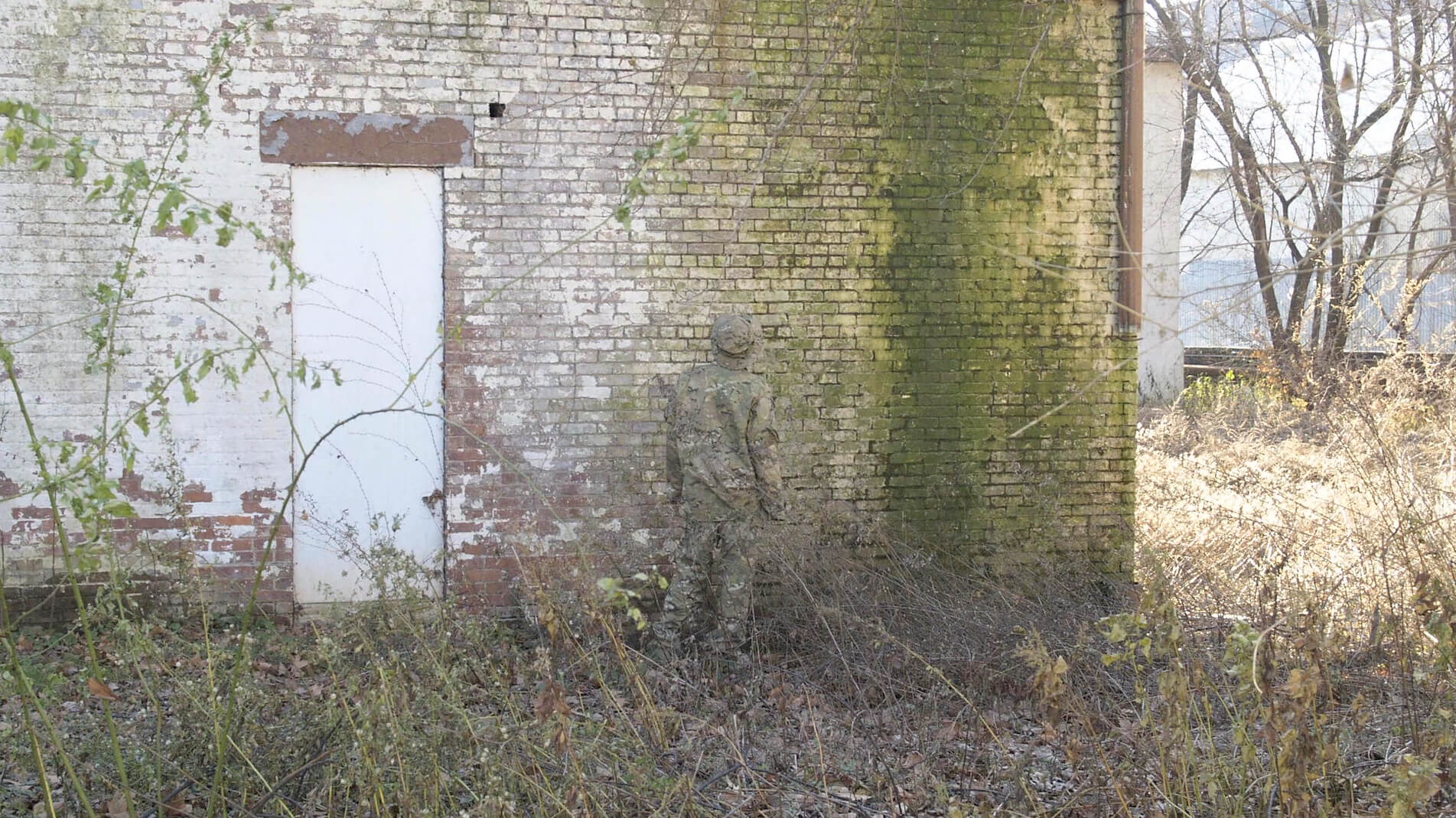 soldier next to a wall