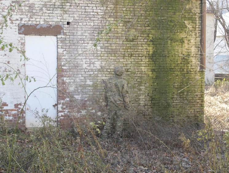 soldier next to a wall