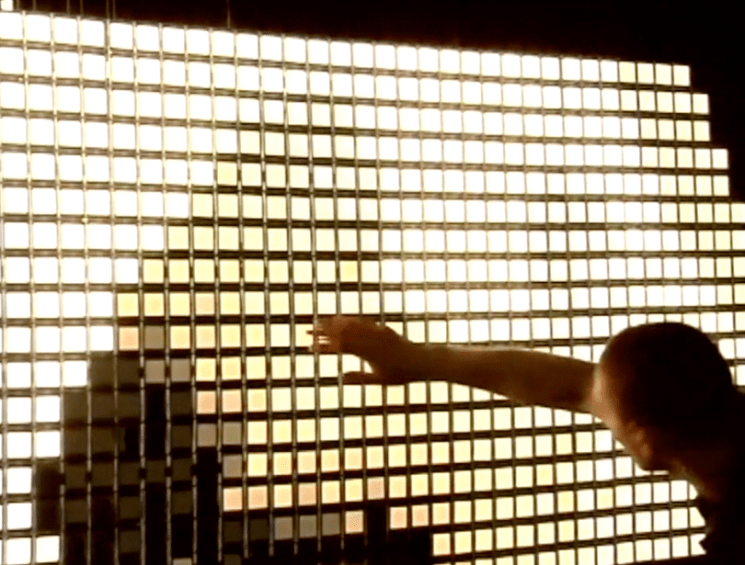 person looking at video art installation