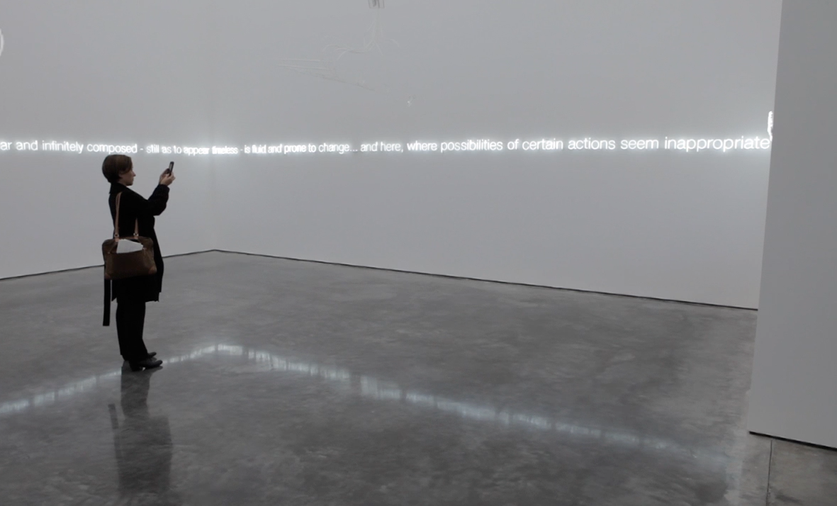 woman taking a photo in a gallery