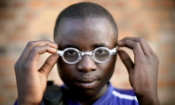 boy putting on glasses