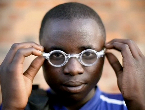 boy putting on glasses