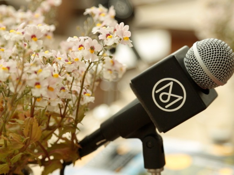 Microphone with the Monocle logo.