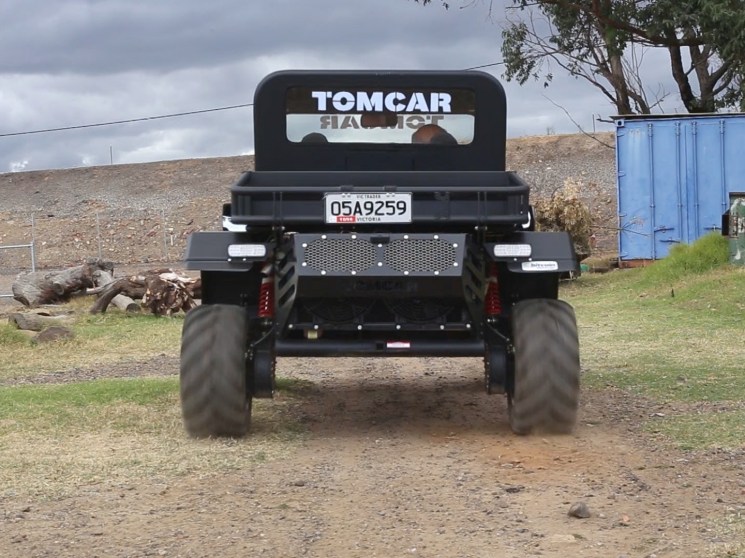 Tomcar parked in the garden.