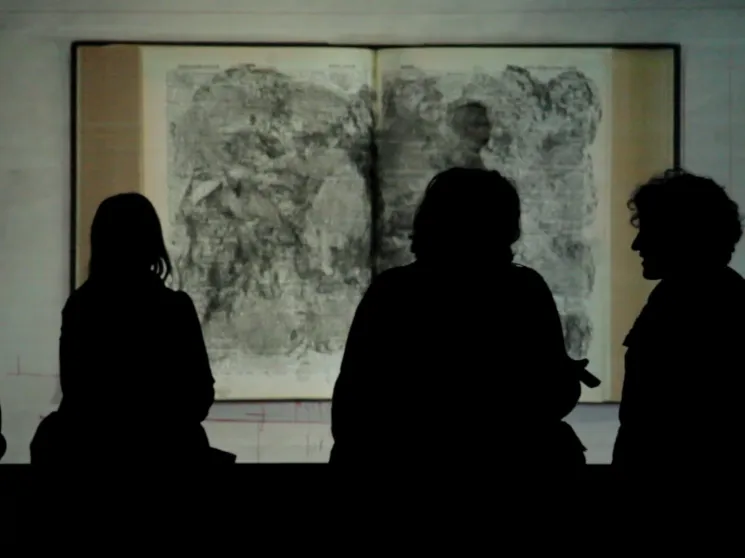 People observing a work of art.
