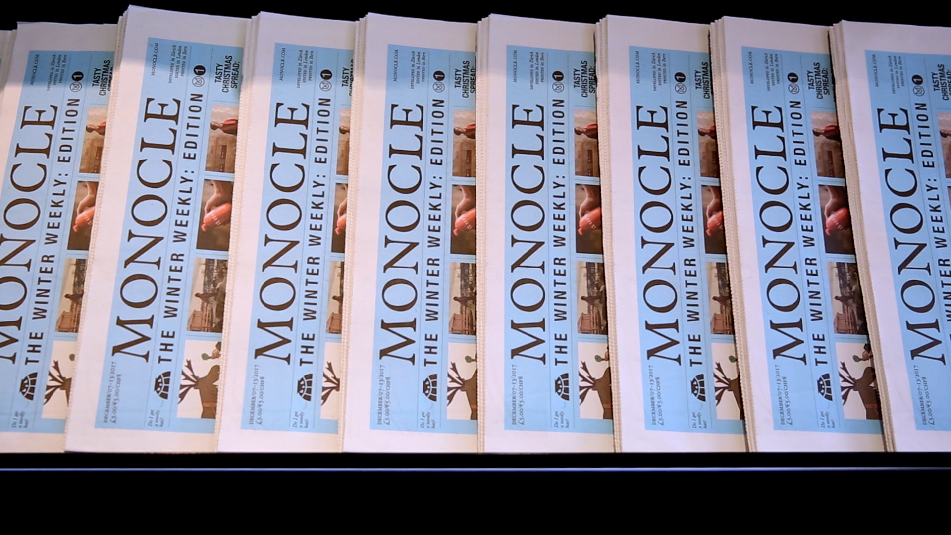 A stack of Monocle The Winter Weekly newspapers.