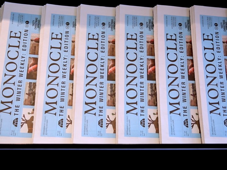 A stack of Monocle The Winter Weekly newspapers.